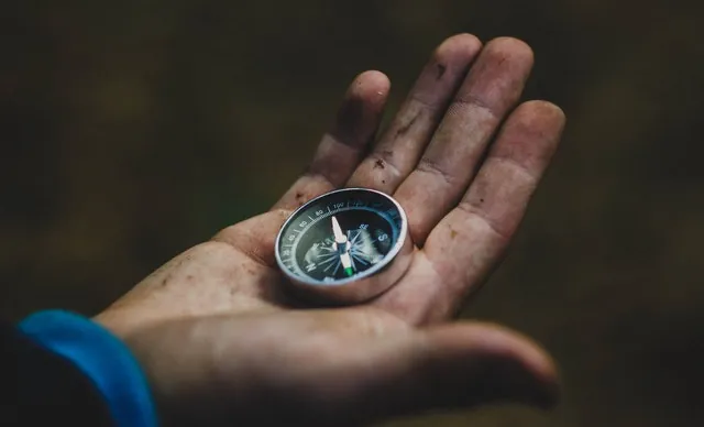 man-holding-compass