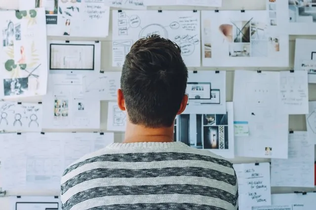 man-standing-in-front-of-whiteboard